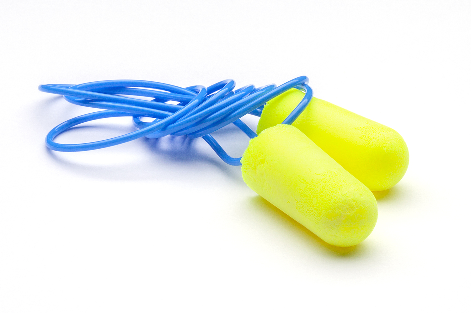 light green earplugs on a lace on a white background